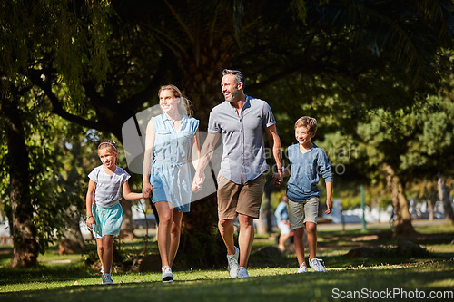 Image of Family is the gift that keeps on giving. a happy young family going for a walk in the park.