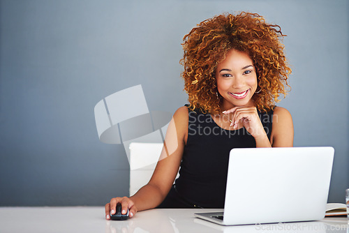 Image of Technology keeps my business current. Portrait of a young businesswoman working on a laptop at her desk.