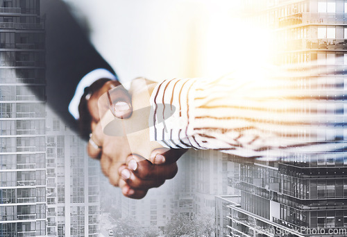 Image of Lets make this partnership work. Closeup shot of two businesspeople shaking hands in an office.