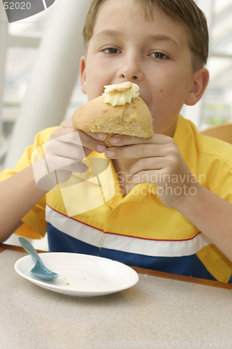 Image of Hungry Appetite:  Child eating a delicious baked muffin