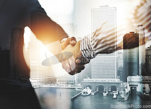 Image of Congratulations on your outstanding achievements. Closeup shot of two unrecognizable businesspeople shaking hands in an office.