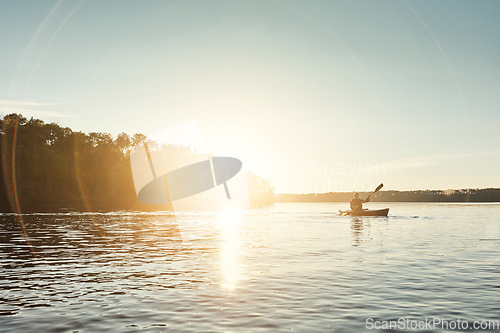 Image of In the middle of nowhere is where you find yourself. a young man kayaking on a lake outdoors.