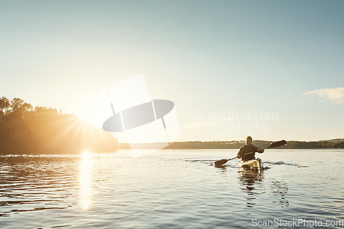 Image of Life is good on the water. a young man kayaking on a lake outdoors.