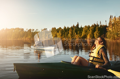 Image of Kayaking is cheaper than therapy. a young couple kayaking on a lake outdoors.