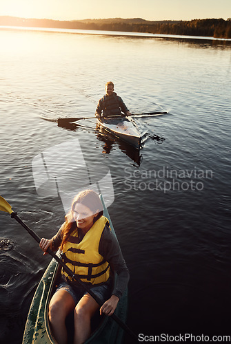 Image of Who wouldve thought this would be so much fun. High angle shot of a young couple kayaking on a lake outdoors.