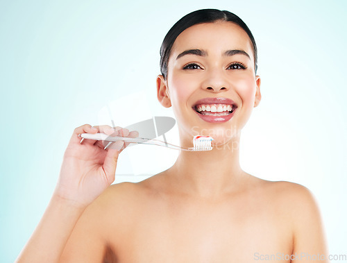 Image of Brush thoroughly. Studio portrait of an attractive young woman brushing her teeth against a light background.