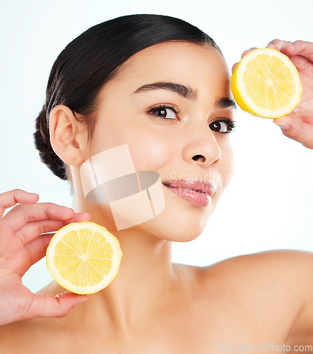 Image of Dont be a lemon. Studio portrait of an attractive young woman posing with a lemon against a light background.