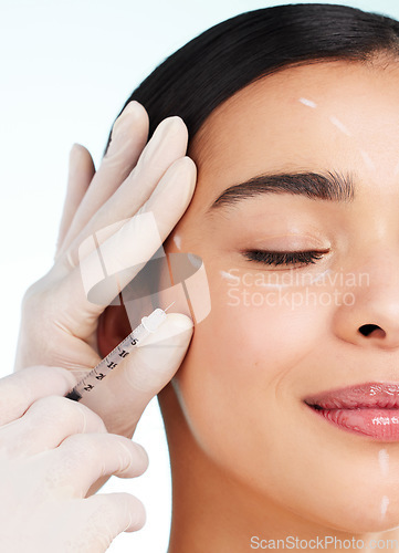 Image of No imperfections allowed. Studio shot of an attractive young woman having some plastic surgery done against a light background.