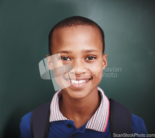 Image of Intelligent and excited to learn. Head and shoulders portrait of a happy african american student standing at the blackboard.