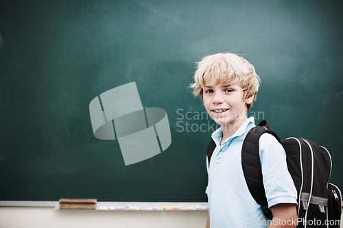 Image of Hes open to so many new ideas. Portrait of a smiling young boy standing alongside copyspace at a blackboard.