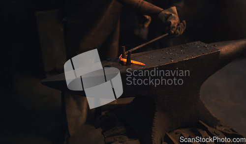 Image of Whats bent can be just as beautiful. a blacksmith working with a hot metal rod in a foundry.