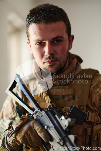 Image of Modern warfare soldier portrait in urban environment