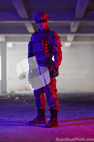 Image of A professional soldier undertakes a perilous mission in an abandoned building illuminated by neon blue and purple lights