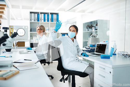 Image of Doing multiple tests until she reaches a perfect outcome. a scientist analysing samples in a lab with her colleague in the background.