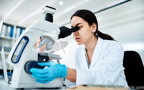 Image of Clinical research and trials are fundamental tools of modern medicine. a young scientist using a microscope in a lab.