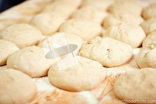 Image of Ready for the oven. a bunch of rolls on a baking tray ready to be placed into the oven.