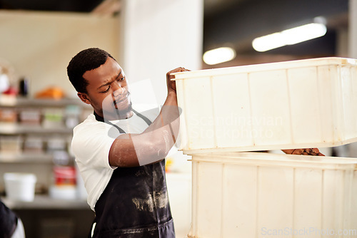 Image of Another day, another bake. a young man working in a bakery.