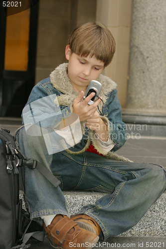 Image of Schoolboy sitting on steps