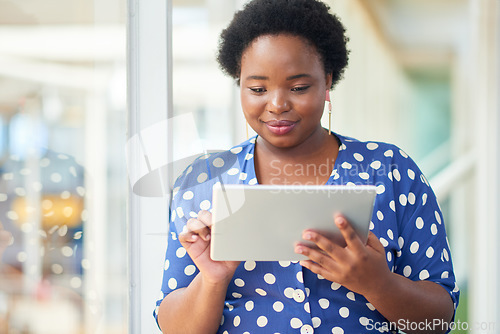 Image of The do your work anywhere device. a young businesswoman using a digital tablet in a modern office.