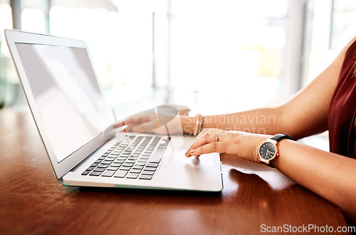 Image of Success only happens once you work for it. Closeup shot of an unrecognisable businesswoman using a laptop in an office.