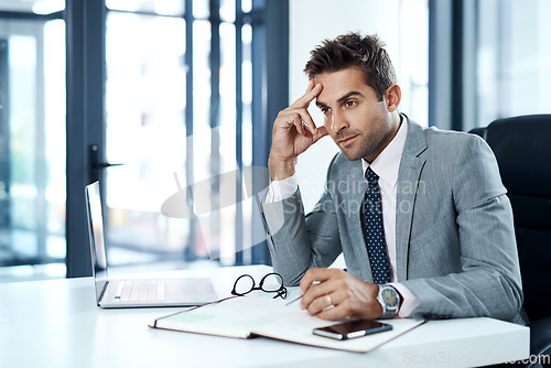 Image of Planning all the necessary steps to succeed. a businessman looking stressed while sitting at his desk.