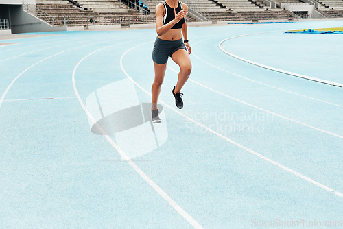 Image of Chasing after my dreams. an unrecognizable athlete running along a track field alone during an outdoor workout session.