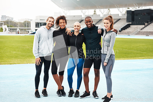 Image of Sore today but stronger tomorrow. Full length portrait of a diverse group of athletes standing together and smiling after an outdoor team training session.