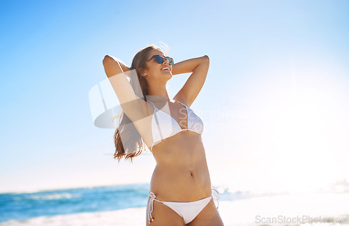 Image of This is my kinda weather. a beautiful young woman enjoying the day at the beach.