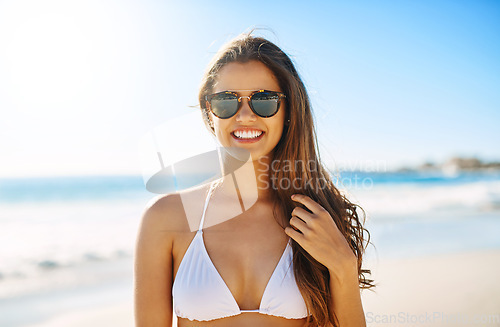 Image of Summer looks so good on her. a beautiful young woman enjoying the day at the beach.