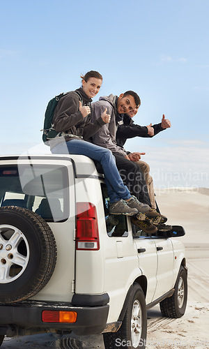 Image of Roadtripping with friends. a group of friends sitting on their car while on a roadtrip.