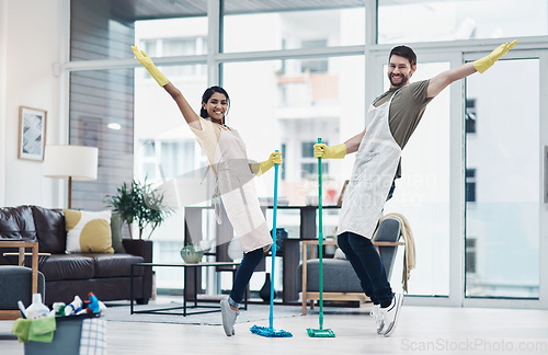 Image of Putting a twist on those daily household tasks. a happy young couple having fun while mopping the floor at home.