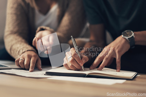 Image of Managing joint finances is a team effort. a couple going over paperwork at home.