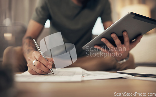 Image of The handiest budgeting tool there is. a man using a digital tablet while going through paperwork at home.