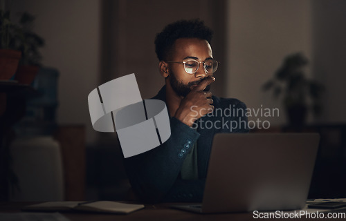 Image of Dedication beats the deadline every time. a young businessman using a laptop during a late night at work.