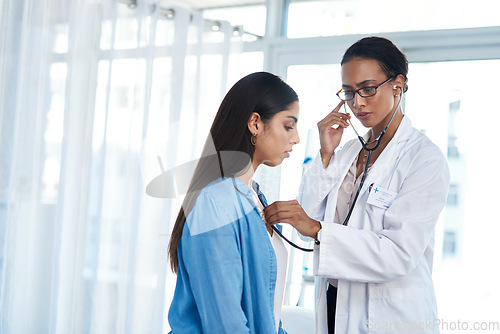 Image of Im picking up some congestion. a young doctor examining her patient with a stethoscope.