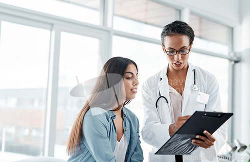 Image of I like the results that Im seeing. a doctor showing a patient her test results.