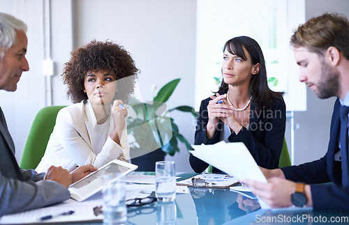 Image of Getting the job done with teamwork. a group of business colleagues meeting in the boardroom.