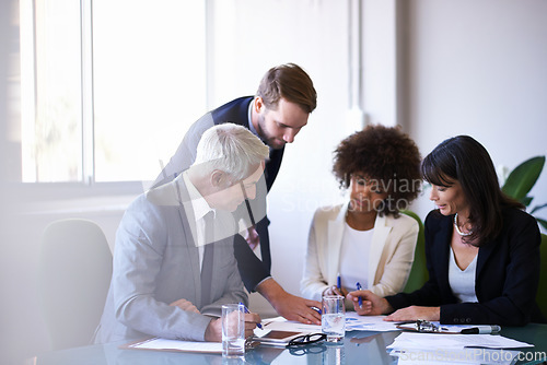 Image of Getting the job done with teamwork. a group of business colleagues meeting in the boardroom.