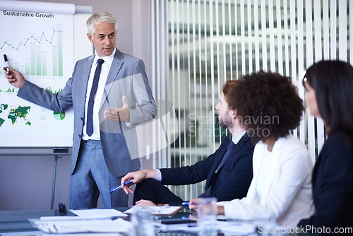 Image of Business discussions. A cropped view of a businessman giving a presentation to his coworkers.