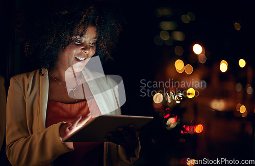 Image of Everyone else is sleeping but not the dedicated. a businesswoman using a digital tablet in an office at night.