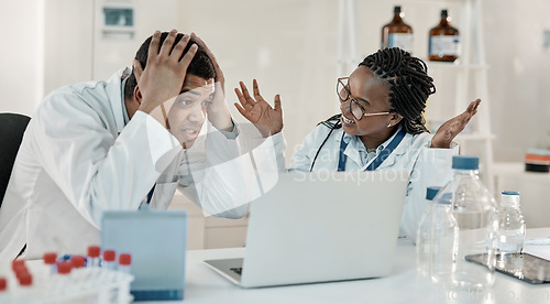 Image of Could this be it. two scientists looking surprised while working together on a laptop in a lab.