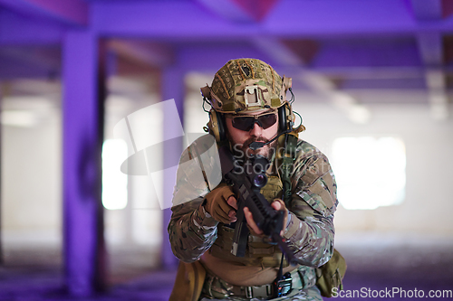 Image of A professional soldier undertakes a perilous mission in an abandoned building illuminated by neon blue and purple lights