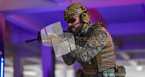 Image of A professional soldier undertakes a perilous mission in an abandoned building illuminated by neon blue and purple lights