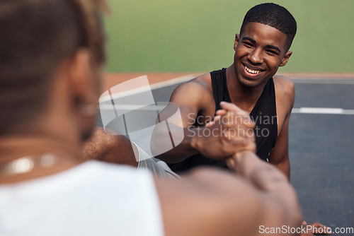 Image of Good sportsmanship encompasses many aspects of a mans character. two sporty young men shaking hands on a basketball court.