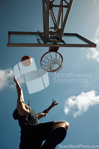 Image of Its all about agility. a sporty young man playing basketball on a sports court.