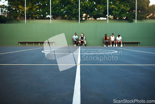 Image of Play hard or go home. a group of sporty young men sitting on a basketball court.