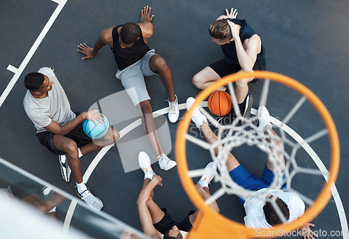 Image of Sport plays an important role in keeping communities together. High angle shot of a group of sporty young men hanging out on a basketball court.