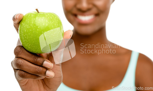 Image of Healthy eating, happy life. Studio shot of an unrecognisable woman eating a green apple against a studio background.