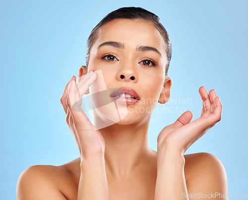 Image of Skip the filter - feel the confidence. Studio portrait of an attractive young woman posing against a blue background.