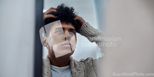 Image of To fix your problem get to the root of it. a handsome young man inspecting his face in the bathroom mirror.